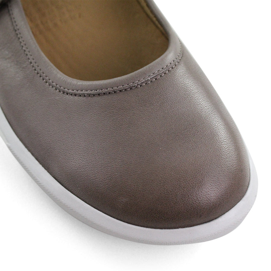 FRONT VIEW OF GREY CASUAL SHOE WITH MARY JANE STYLE STRAP ACROSS THE TOP  AND WHITE STITCH DETAIL   