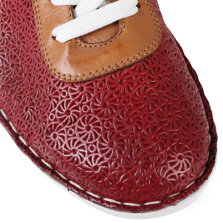 FRONT VIEW OF PATTERNED RED LEATHER LACE UP SNEAKER WITH TAN PANELS AND WHITE SOLE 