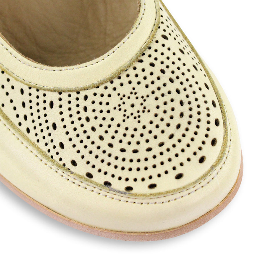 FRONT VIEW OF YELLOW CASUAL SHOE WITH VELCRO STRAP AND LASER CUT DETAILING 