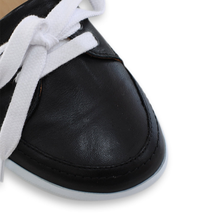 FRONT VIEW OF BLACK CASUAL SHOE WITH LACES AT THE FRONT AND WHITE SOLE 