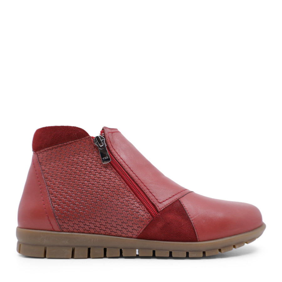 SIDE VIEW OF RED ANKLE BOOT WITH SUEDE ATCHWORK DETAIL AND RUBBER SOLE 