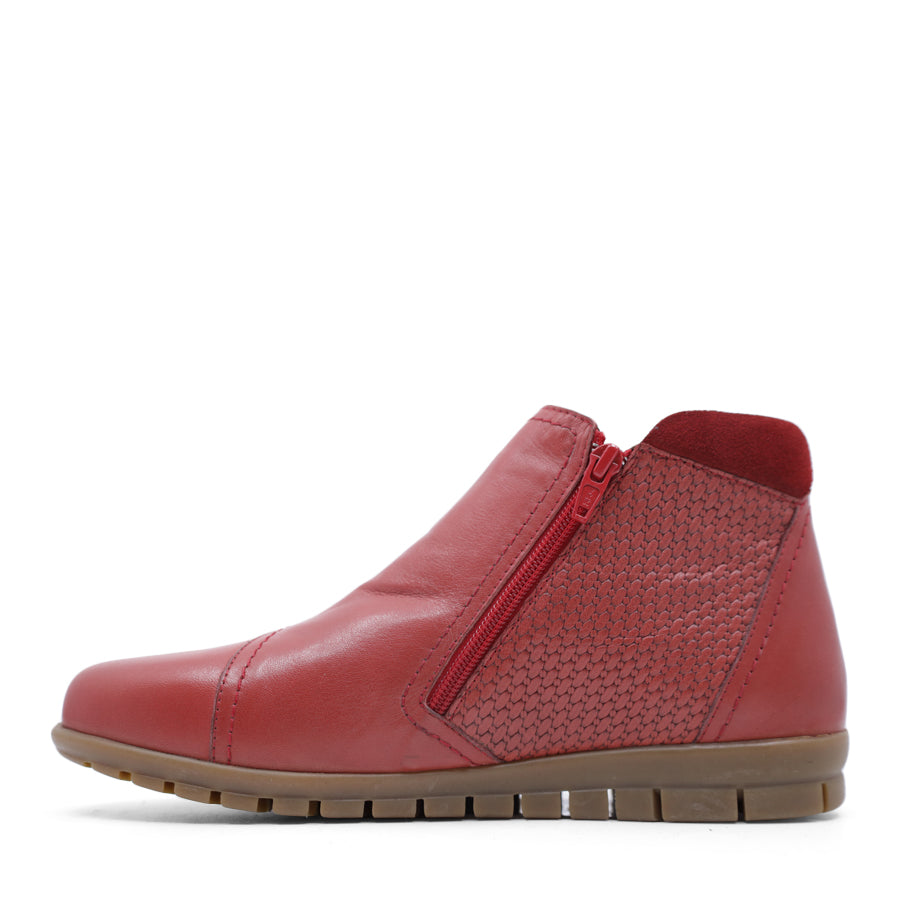 SIDE VIEW OF RED ANKLE BOOT WITH SUEDE ATCHWORK DETAIL AND RUBBER SOLE 