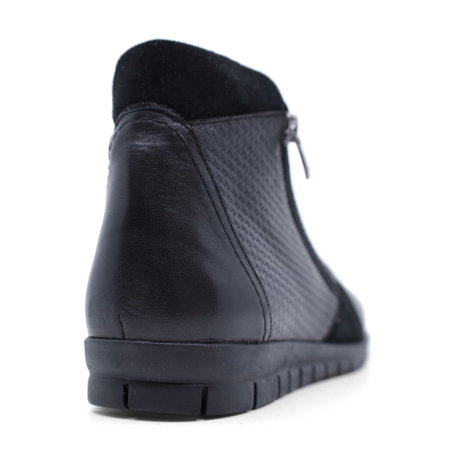 BACK VIEW OF BLACK ANKLE BOOT WITH SUEDE ATCHWORK DETAIL AND RUBBER SOLE 