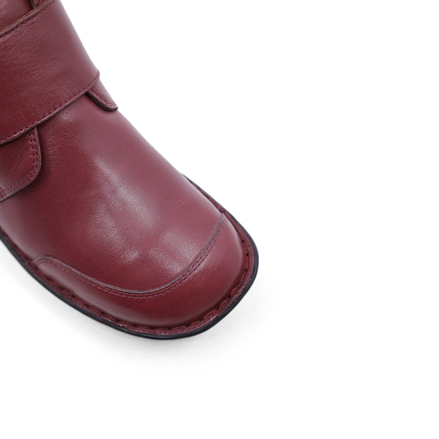 FRONT VIEW OF RED LEATHER ANKLE BOOT WITH STRAP