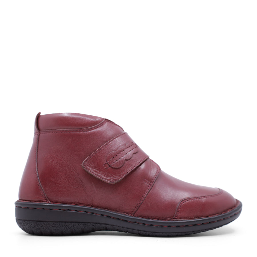 SIDE VIEW OF RED LEATHER ANKLE BOOT WITH STRAP