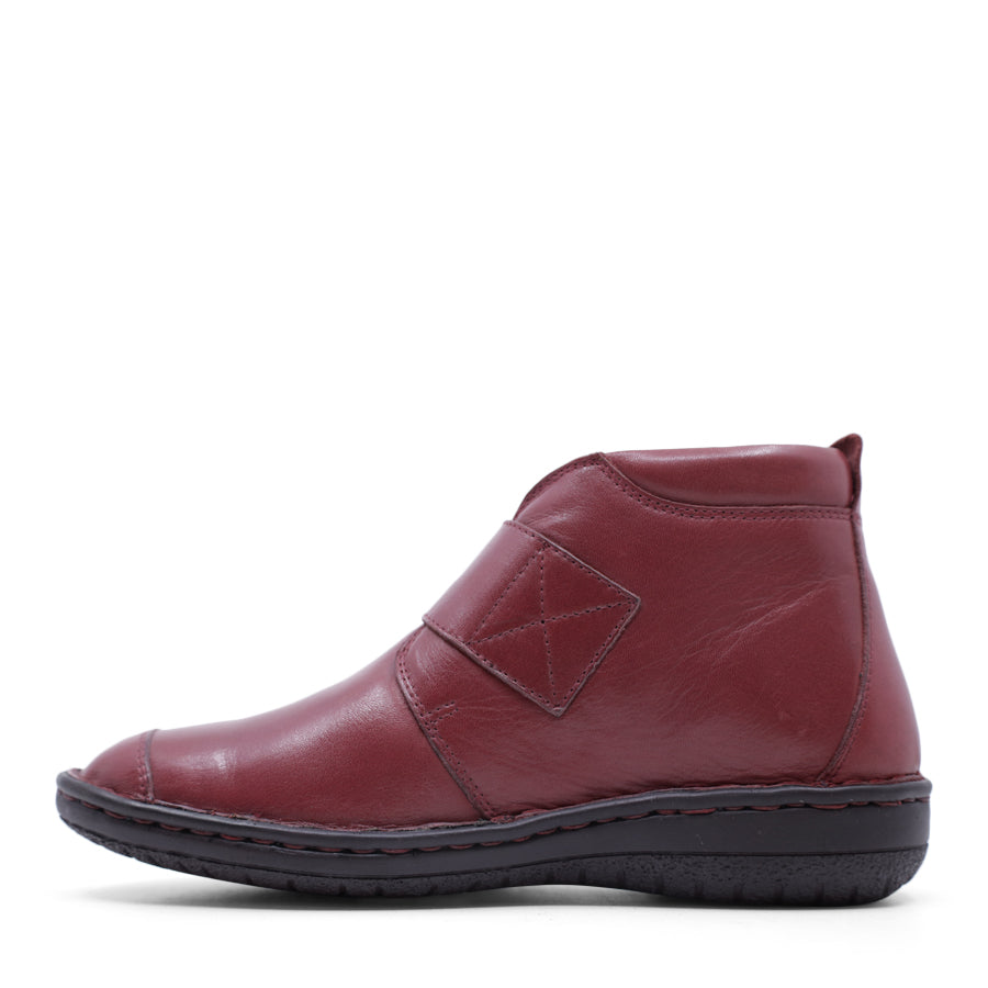 SIDE VIEW OF RED LEATHER ANKLE BOOT WITH STRAP