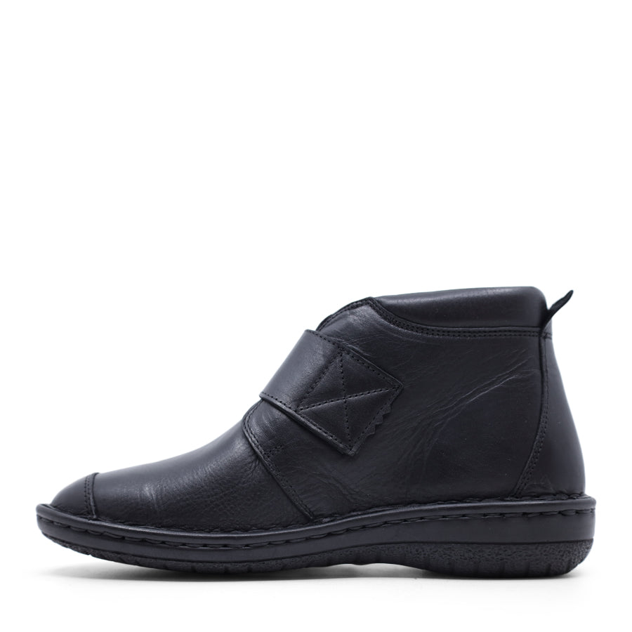 SIDE VIEW OF BLACK LEATHER ANKLE BOOT WITH STRAP