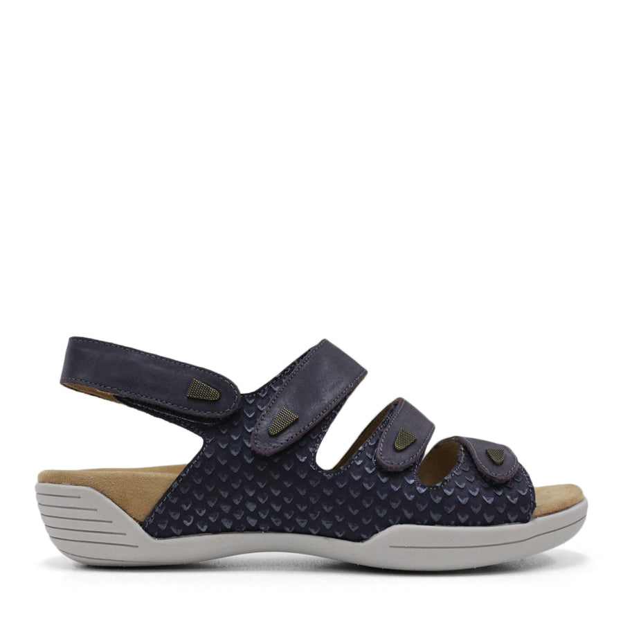   SIDE VIEW OF GREEN FLAT SANDAL WITH 3 STRAPS OVER THE FOOT AND ONE AROUND THE HEEL. TRIANGLE PATTERN DETAIL. 