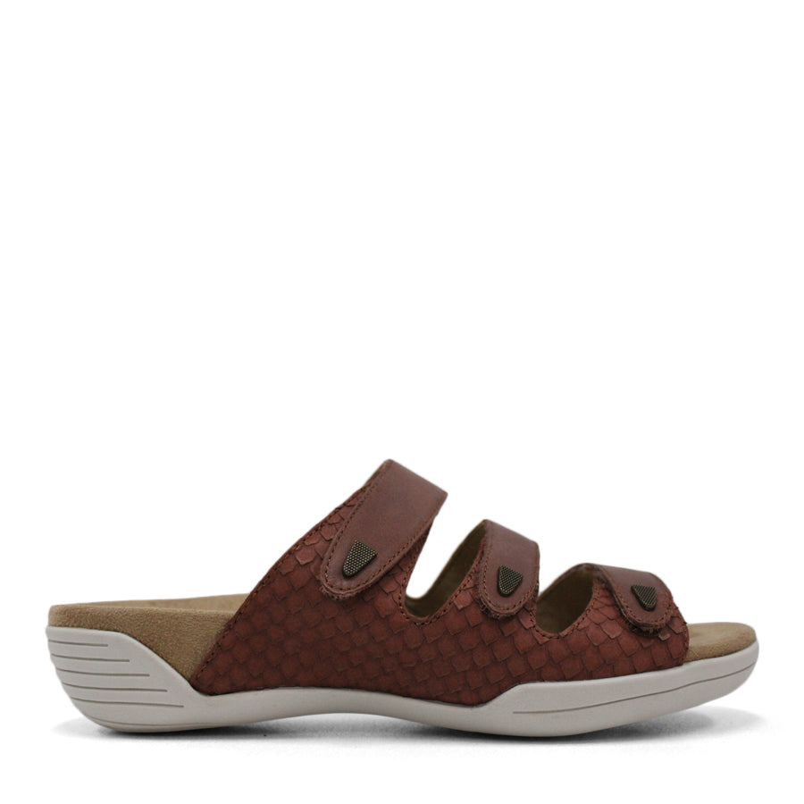 SIDE VIEW OF RED FLAT SANDAL WITH TRANGLE TEXTURED SIDE PANELS, OPEN TOE, OPEN BACK, WHITE SOLE AND THREE STRAPS ACROSS THE FRONT 