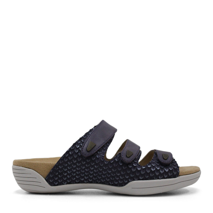 SIDE VIEW OF RED FLAT SANDAL WITH TRANGLE TEXTURED SIDE PANELS, OPEN TOE, OPEN BACK, WHITE SOLE AND THREE STRAPS ACROSS THE FRONT 