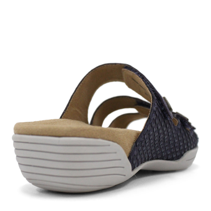 BACK VIEW OF BLUE FLAT SANDAL WITH TRANGLE TEXTURED SIDE PANELS, OPEN TOE, OPEN BACK, WHITE SOLE AND THREE STRAPS ACROSS THE FRONT 