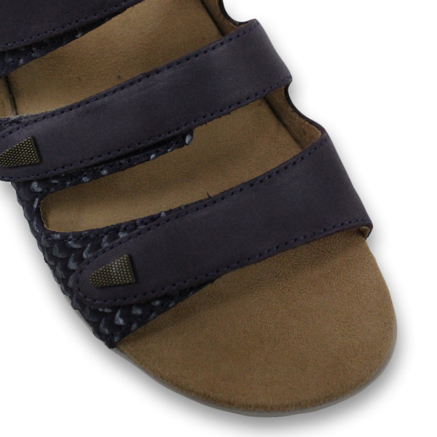 FRONT VIEW OF BLUE FLAT SANDAL WITH TRANGLE TEXTURED SIDE PANELS, OPEN TOE, OPEN BACK, WHITE SOLE AND THREE STRAPS ACROSS THE FRONT 
