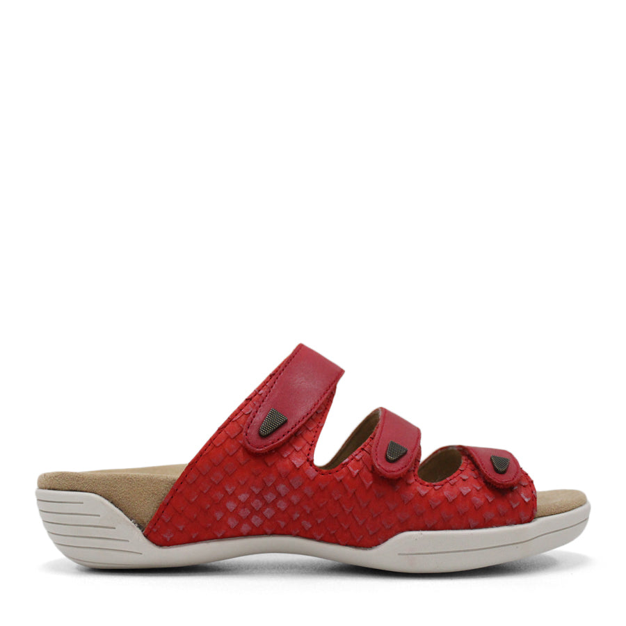 SIDE VIEW OF RED FLAT SANDAL WITH TRANGLE TEXTURED SIDE PANELS, OPEN TOE, OPEN BACK, WHITE SOLE AND THREE STRAPS ACROSS THE FRONT 