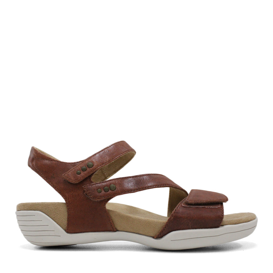 SIDE VIEW OF BROWN FLAT SANDAL WITH OPEN TOE, OPEN BACK, WHITE SOLE AND THREE STRAPS ACROSS THE FRONT 