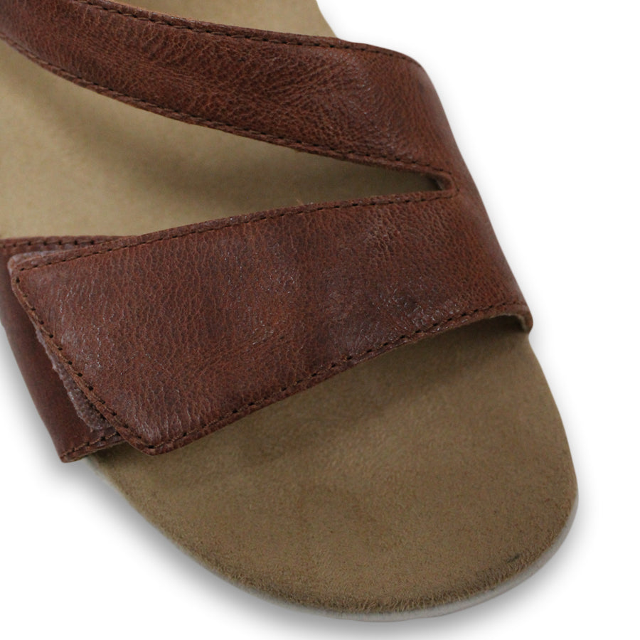 FRONT VIEW OF BROWN FLAT SANDAL WITH OPEN TOE, OPEN BACK, WHITE SOLE AND THREE STRAPS ACROSS THE FRONT 