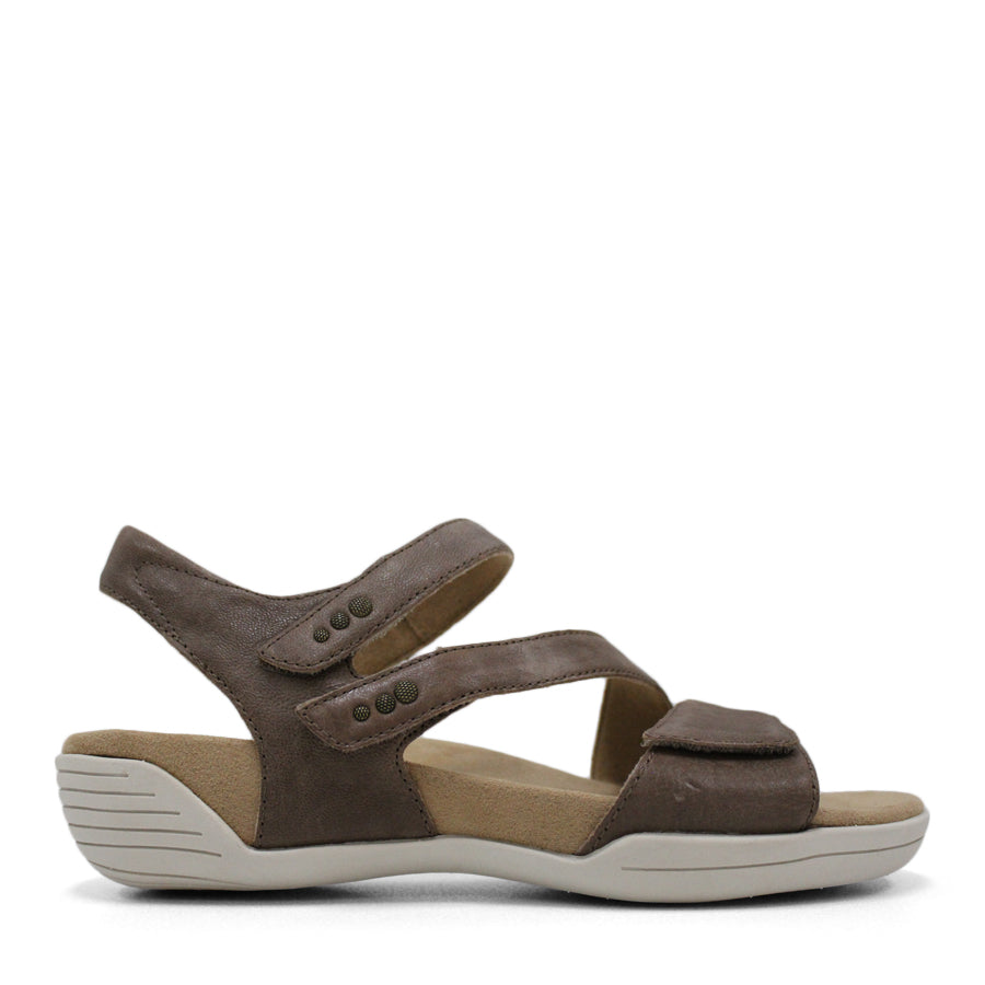 SIDE VIEW OF BROWN FLAT SANDAL WITH OPEN TOE, OPEN BACK, WHITE SOLE AND THREE STRAPS ACROSS THE FRONT 