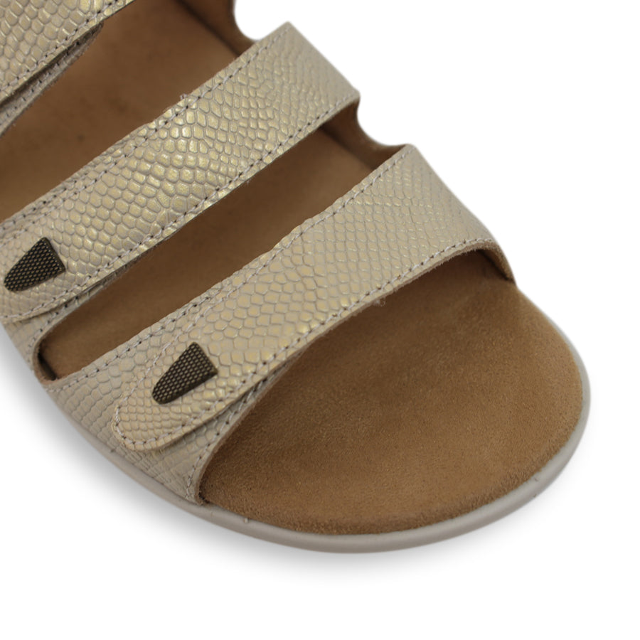 FRONT VIEW OF GOLD FLAT SANDAL WITH TRANGLE TEXTURED SIDE PANELS, OPEN TOE, OPEN BACK, WHITE SOLE AND THREE STRAPS ACROSS THE FRONT 