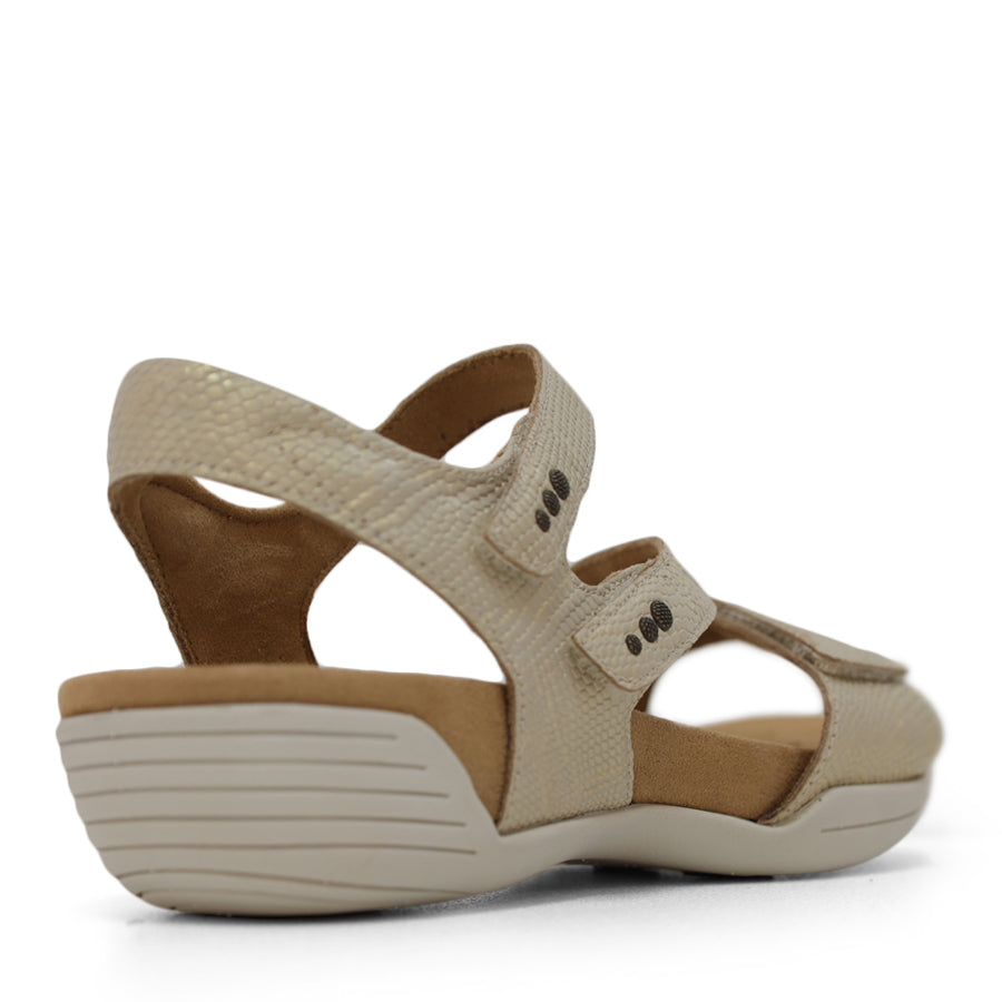 BACK VIEW OF GOLD FLAT SANDAL WITH OPEN TOE, OPEN BACK, WHITE SOLE AND THREE STRAPS ACROSS THE FRONT 