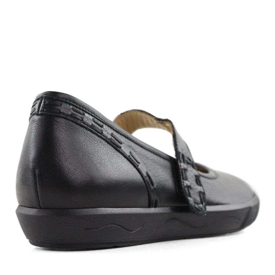 BACK VIEW OF BLACK CASUAL SHOE WITH MARY JANE STYLE STRAP ACROSS THE TOP
