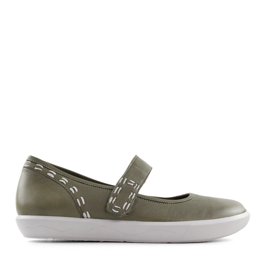 SIDE VIEW OF GREEN CASUAL SHOE WITH MARY JANE STYLE STRAP ACROSS THE TOP AND WHITE STITCH DETAIL  