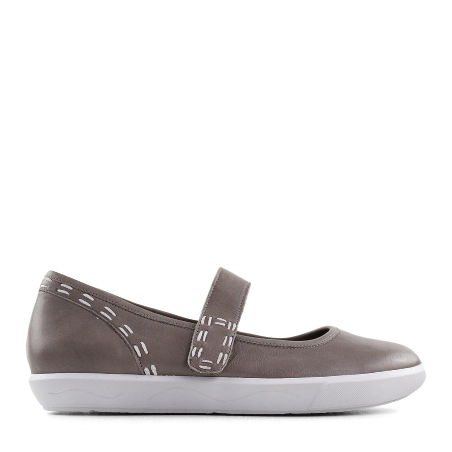 SIDE VIEW OF BLACK CASUAL SHOE WITH MARY JANE STYLE STRAP ACROSS THE TOP  AND WHITE STITCH DETAIL   