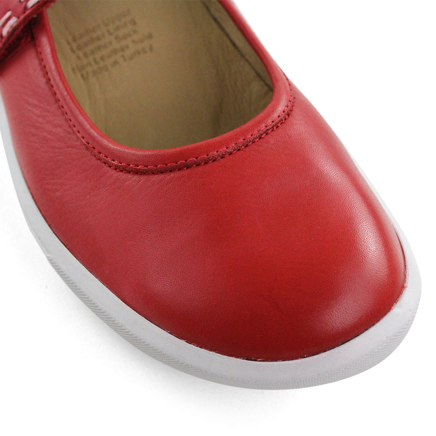 FRONT VIEW OF RED CASUAL SHOE WITH MARY JANE STYLE STRAP ACROSS THE TOP  AND WHITE STITCH DETAIL   