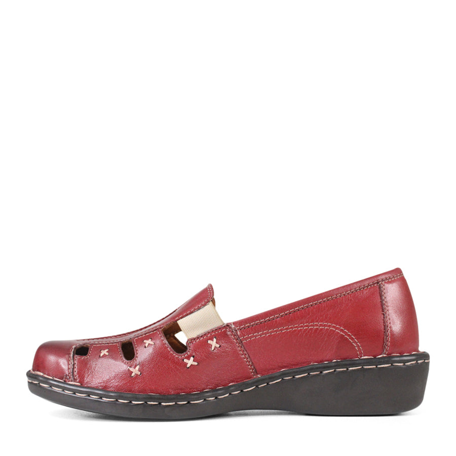 SIDE VIEW OF RED LEATHER SANDAL WITH WHITE CROSS STITCHING DETAIL