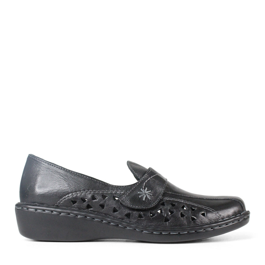 SIDE VIEW OF BLACK LEATHER CASUAL SHOE WITH VELCRO STRAP AND TRIANGLE SHAPED CUTOUTS ON THE SIDE