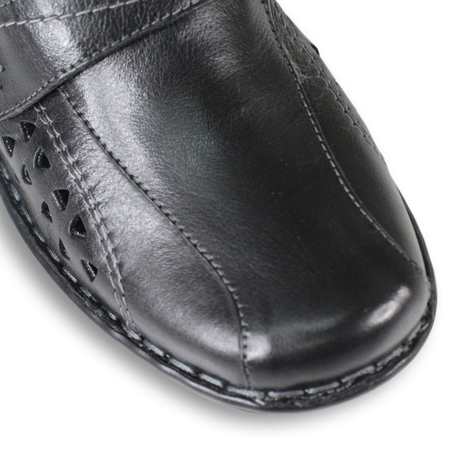 FRONT VIEW OF BLACK LEATHER CASUAL SHOE WITH VELCRO STRAP AND TRIANGLE SHAPED CUTOUTS ON THE SIDE