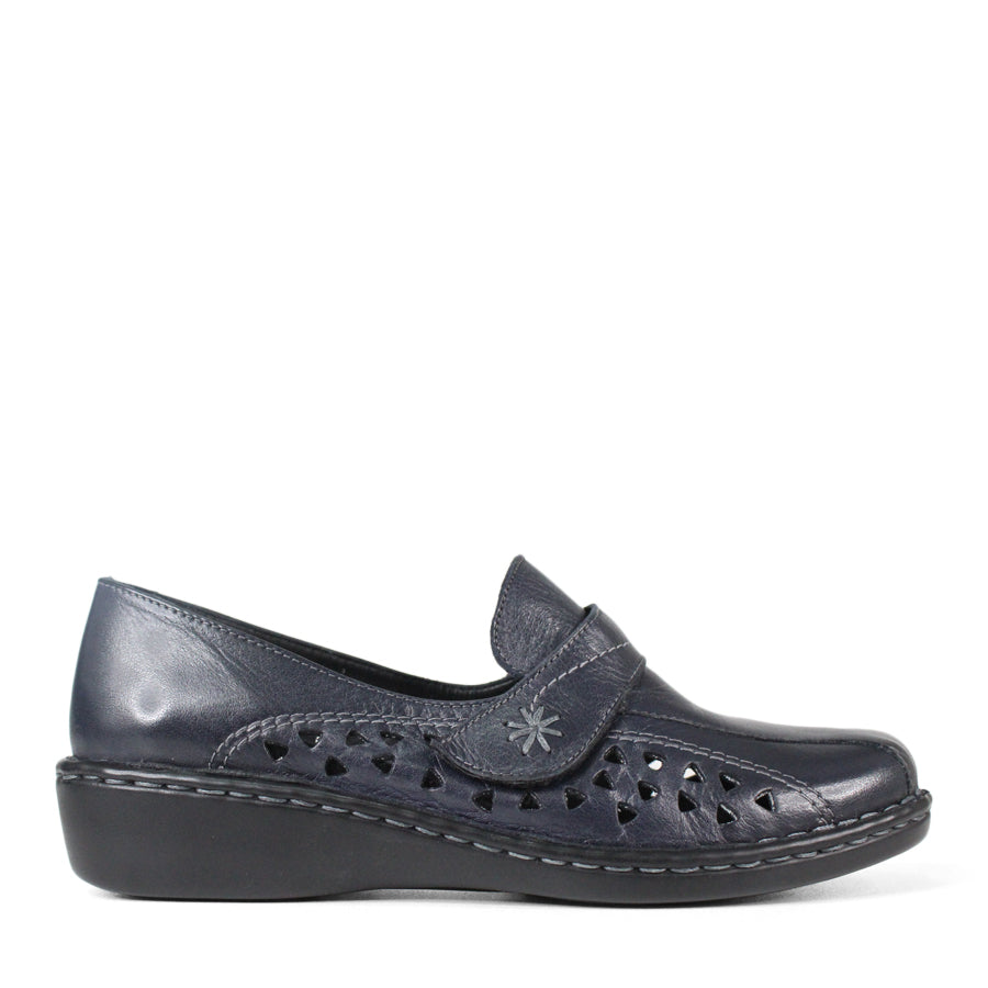 SIDE VIEW OF NAVY LEATHER CASUAL SHOE WITH VELCRO STRAP AND TRIANGLE SHAPED CUTOUTS ON THE SIDE