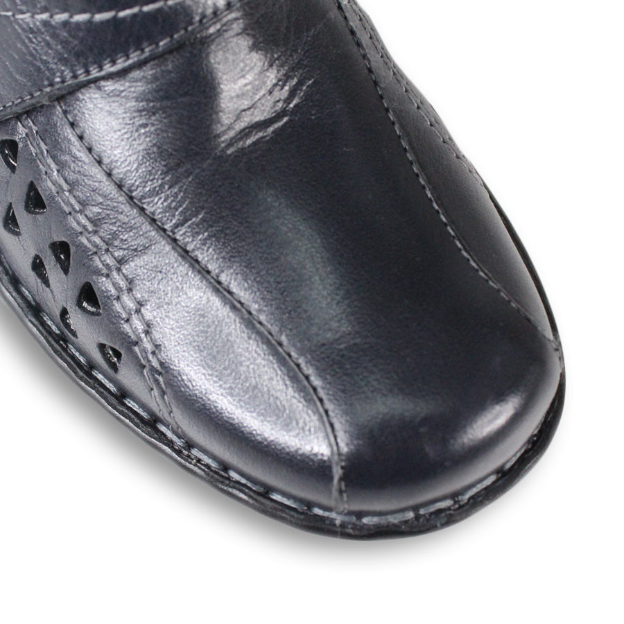 FRONT VIEW OF NAVY LEATHER CASUAL SHOE WITH VELCRO STRAP AND TRIANGLE SHAPED CUTOUTS ON THE SIDE