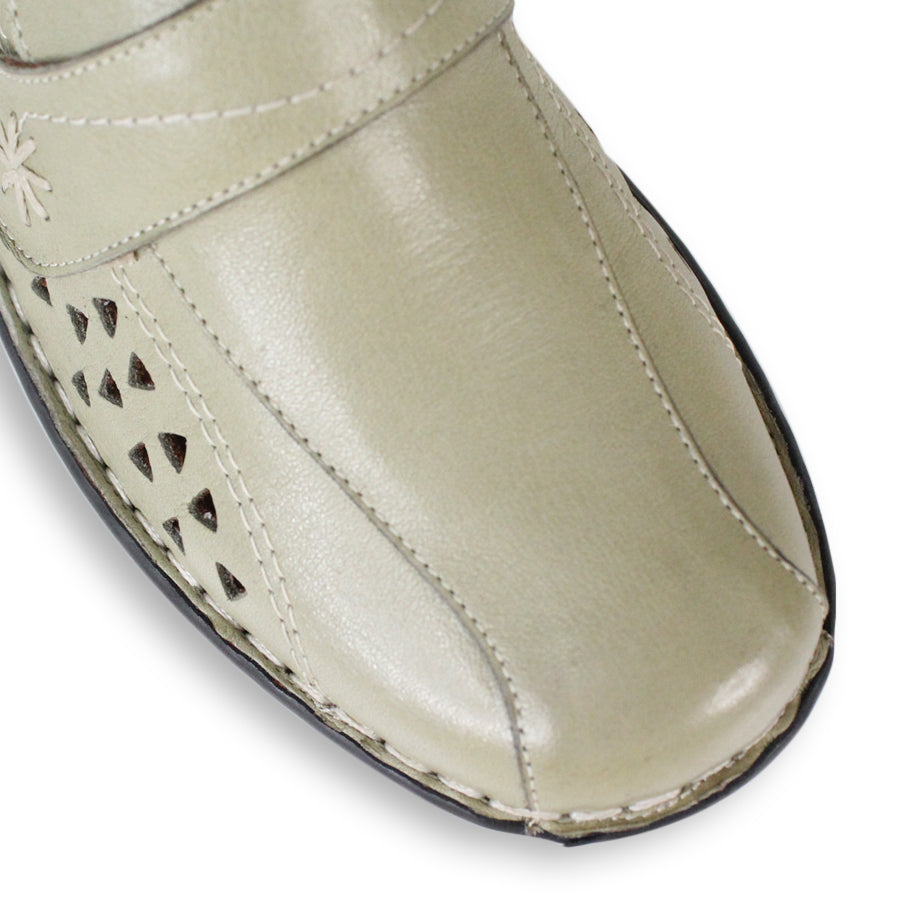 FRONT VIEW OF LIGHT GREEN LEATHER CASUAL SHOE WITH VELCRO STRAP AND TRIANGLE SHAPED CUTOUTS ON THE SIDE