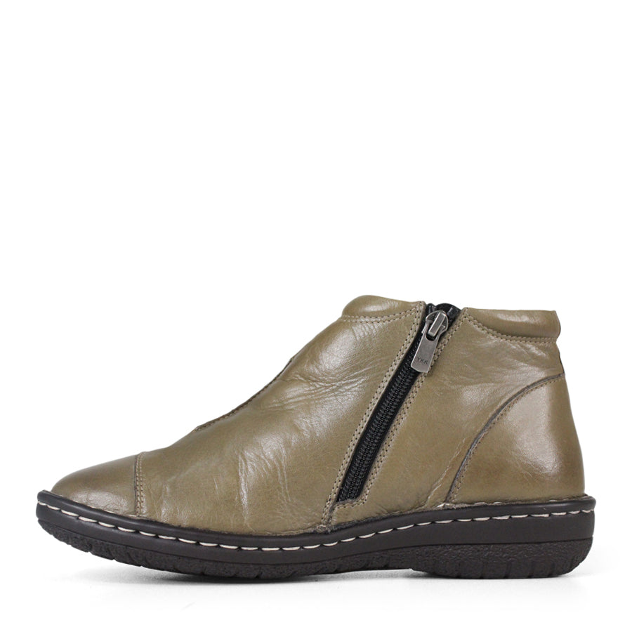 SIDE VIEW OF GREEN LEATHER ANKLE BOOT WITH SIDE ZIPPER, BLACK SOLE WITH WHITE STITCHING 