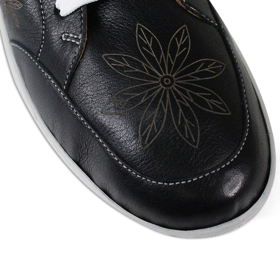 FRONT VIEW OF BLACK LACE UP CASUAL SHOE WITH WHITE SOLE AND WHITE STITCHING. FLOWERS ON THE SIDES AND TOP OF THE SHOE 