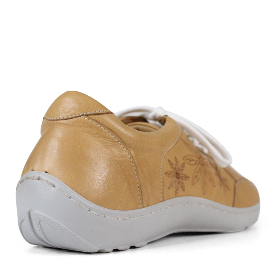 BACK VIEW OF BEIGE LACE UP CASUAL SHOE WITH WHITE SOLE AND WHITE STITCHING. FLOWERS ON THE SIDES AND TOP OF THE SHOE 