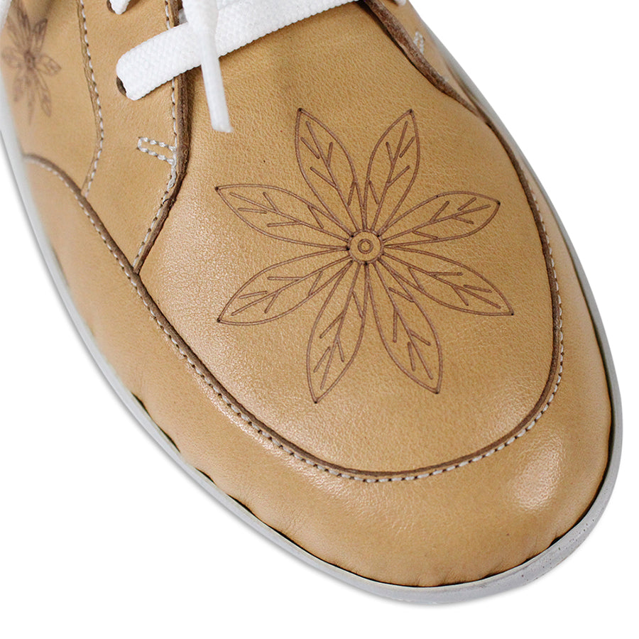 FRONT VIEW OF BEIGE LACE UP CASUAL SHOE WITH WHITE SOLE AND WHITE STITCHING. FLOWERS ON THE SIDES AND TOP OF THE SHOE 