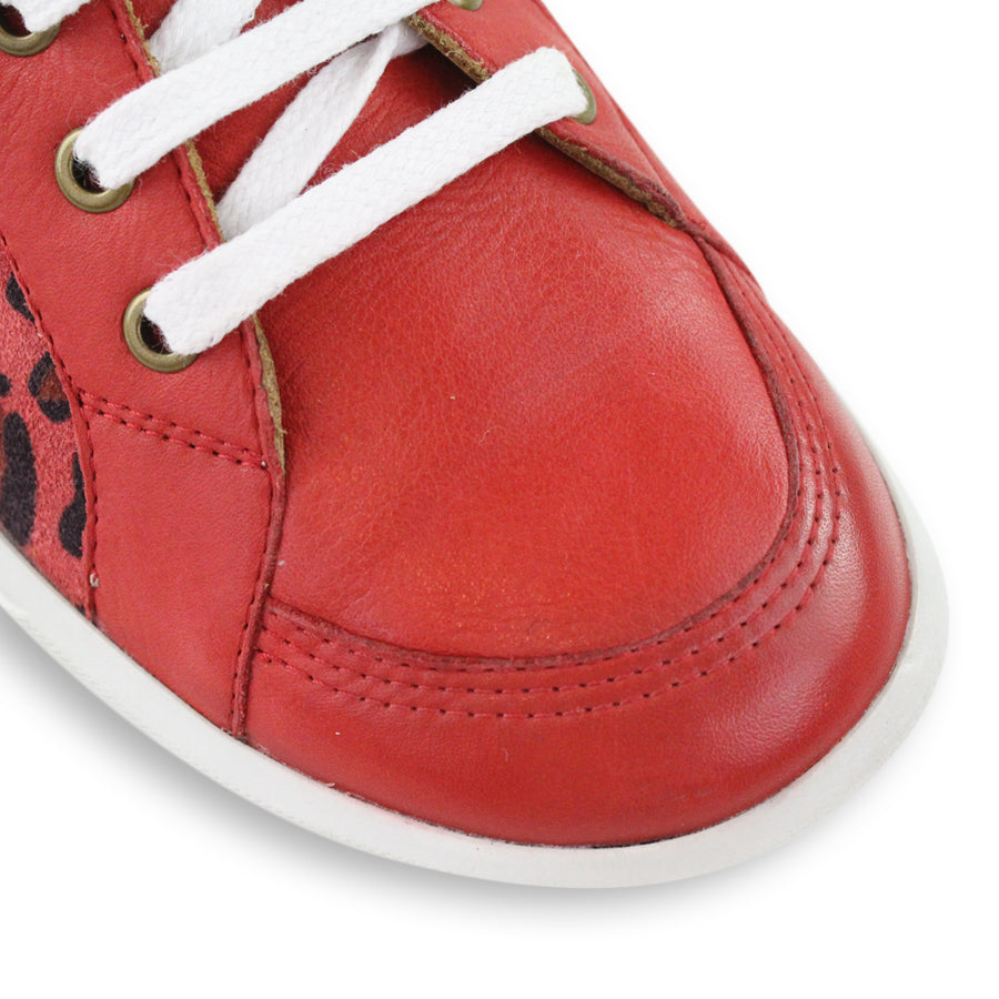 FRONT VIEW OF RED LACE UP SNEAKER WITH LEOPARD PRINT PANELS ON THE SIDES 
