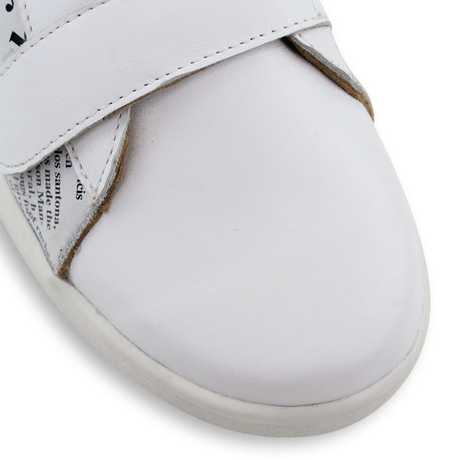 FRONT VIEW OF WHITE NEWSPAPER PRINT SNEAKER WITH TWO VELCRO STRAPS AND WHITE SOLE 
