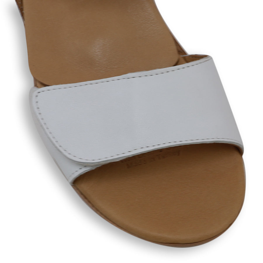FRONT VIEW OF WHITE SANDAL WITH VELCRO STRAP AND SMALL HEEL 