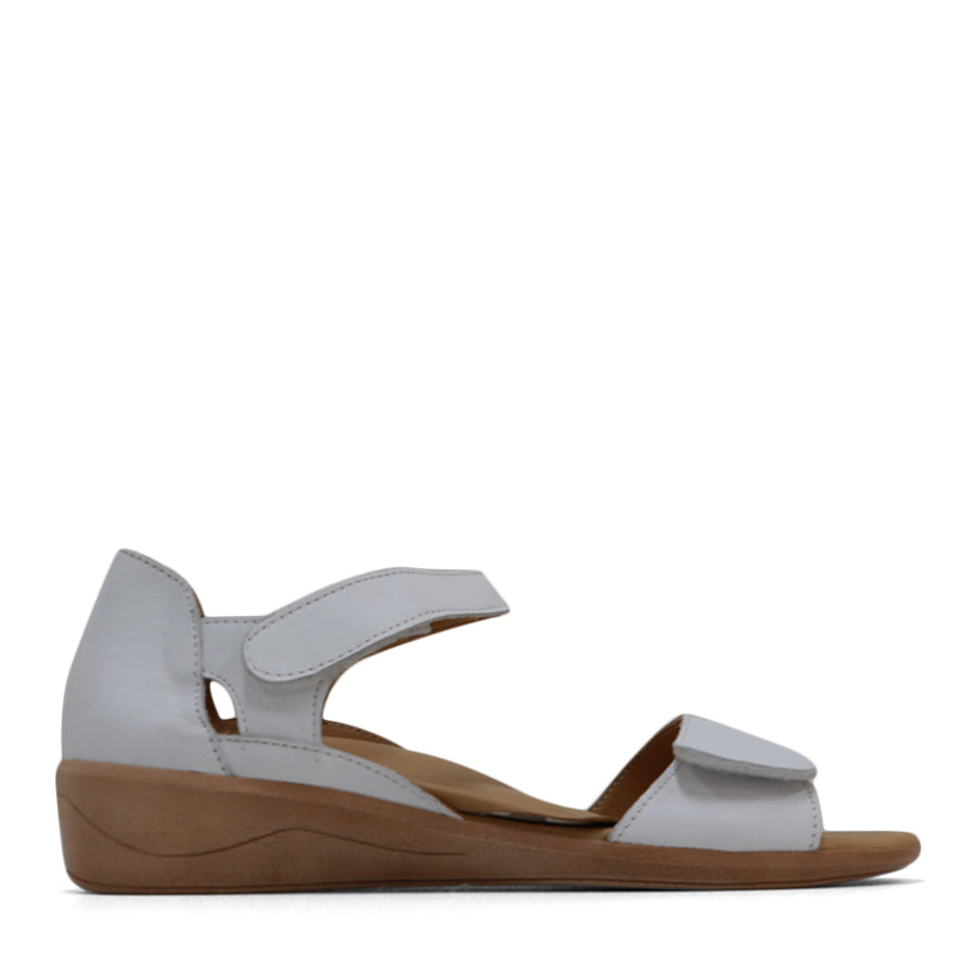 SIDE VIEW OF WHITE SANDAL WITH VELCRO STRAP AND SMALL HEEL 