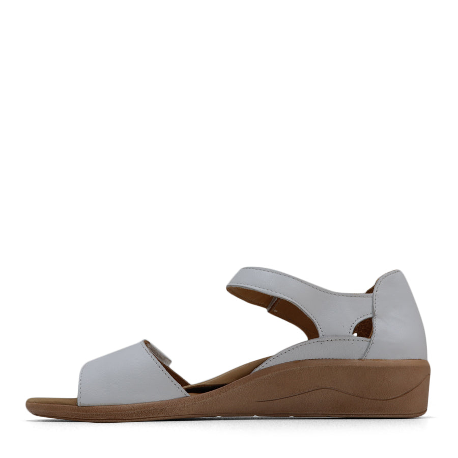 SIDE VIEW OF WHITE SANDAL WITH VELCRO STRAP AND SMALL HEEL 