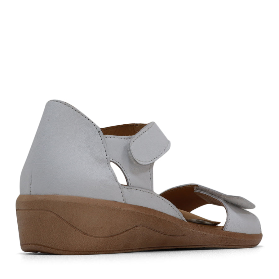 BACK VIEW OF WHITE SANDAL WITH VELCRO STRAP AND SMALL HEEL 