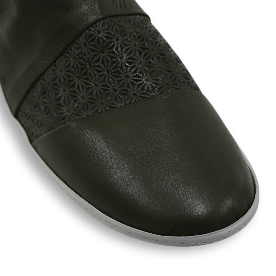 FRONT VIEW OF GREEN LEATHER ANKLE BOOT WITH WHITE SOLE AND PATTERNED DETAIL PANELLING 