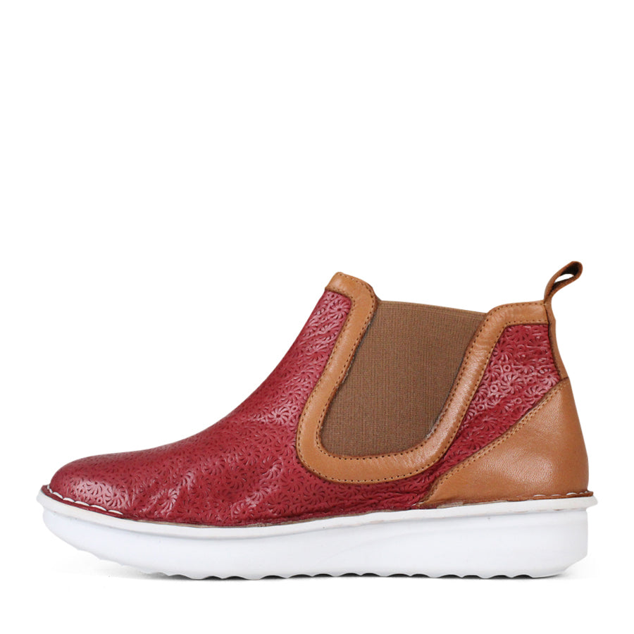 SIDE VIEW OF PATTERNED RED ANKLE BOOT WITH TAN PANELS AND WHITE SOLE 