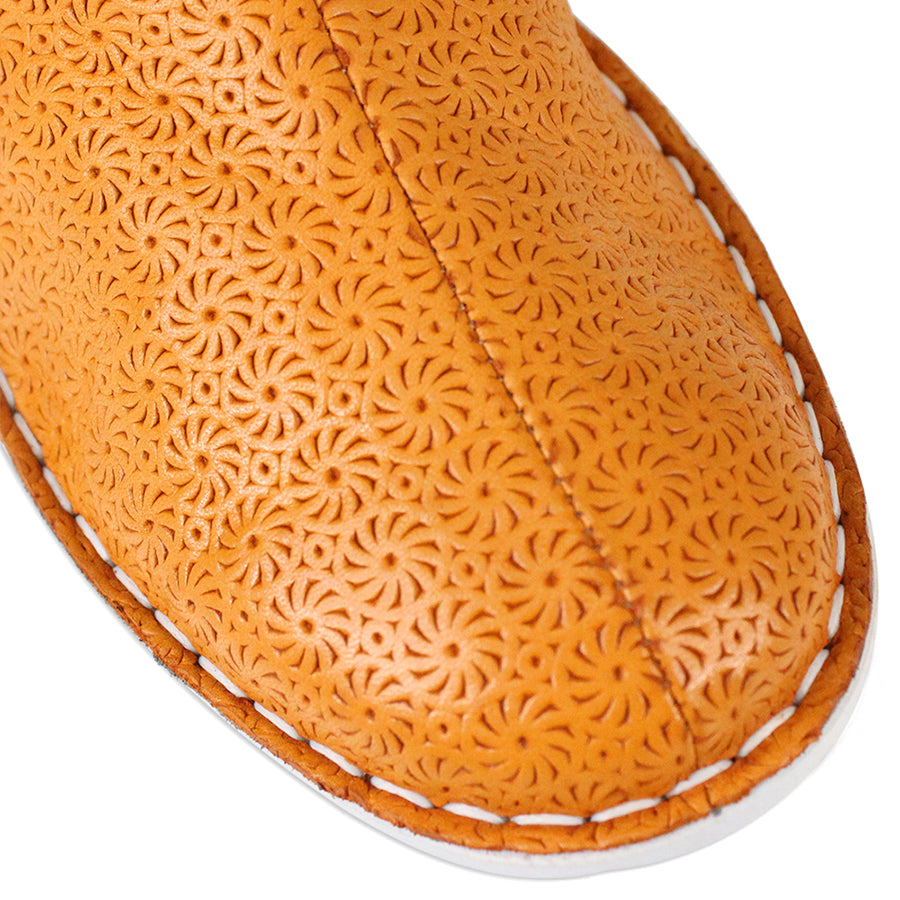 FRONT VIEW OF PATTERNED YELLOW ANKLE BOOT WITH TAN PANELS AND WHITE SOLE 