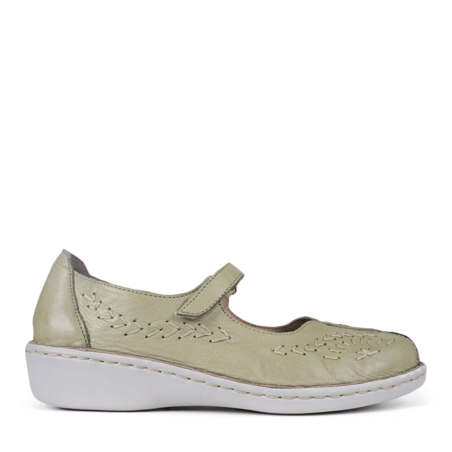 SIDE VIEW OF LIGHT GREEN LEATHER CASUAL SHOE WITH VELCRO STRAP AND WHITE STITCHING DETAIL