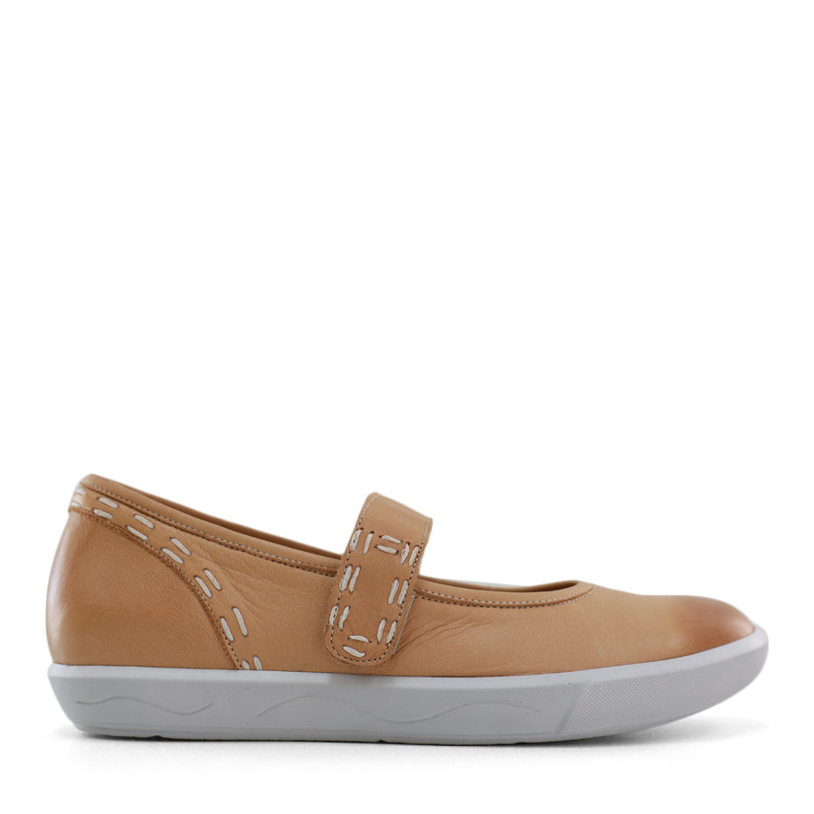 SIDE VIEW OF BEIGE CASUAL SHOE WITH MARY JANE STYLE STRAP ACROSS THE TOP  AND WHITE STITCH DETAIL   