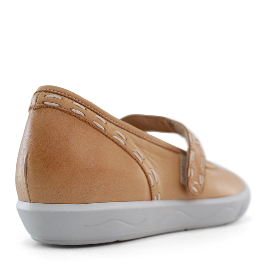 BACK VIEW OF BEIGE CASUAL SHOE WITH MARY JANE STYLE STRAP ACROSS THE TOP  AND WHITE STITCH DETAIL   