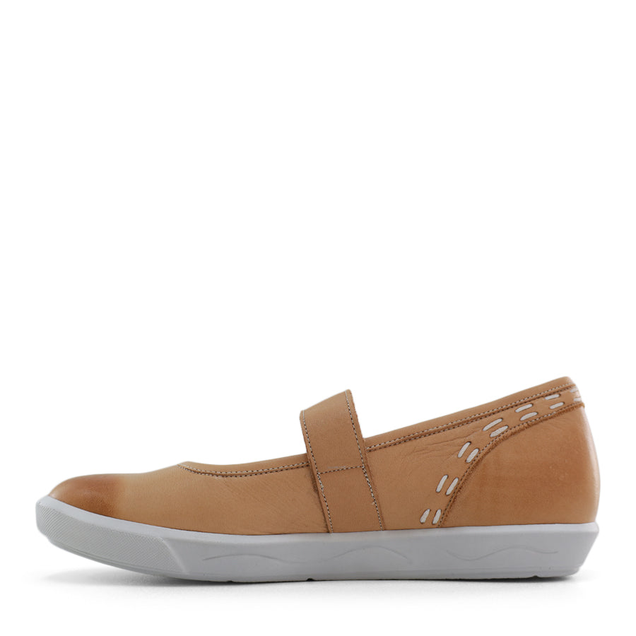 SIDE VIEW OF BEIGE CASUAL SHOE WITH MARY JANE STYLE STRAP ACROSS THE TOP  AND WHITE STITCH DETAIL   