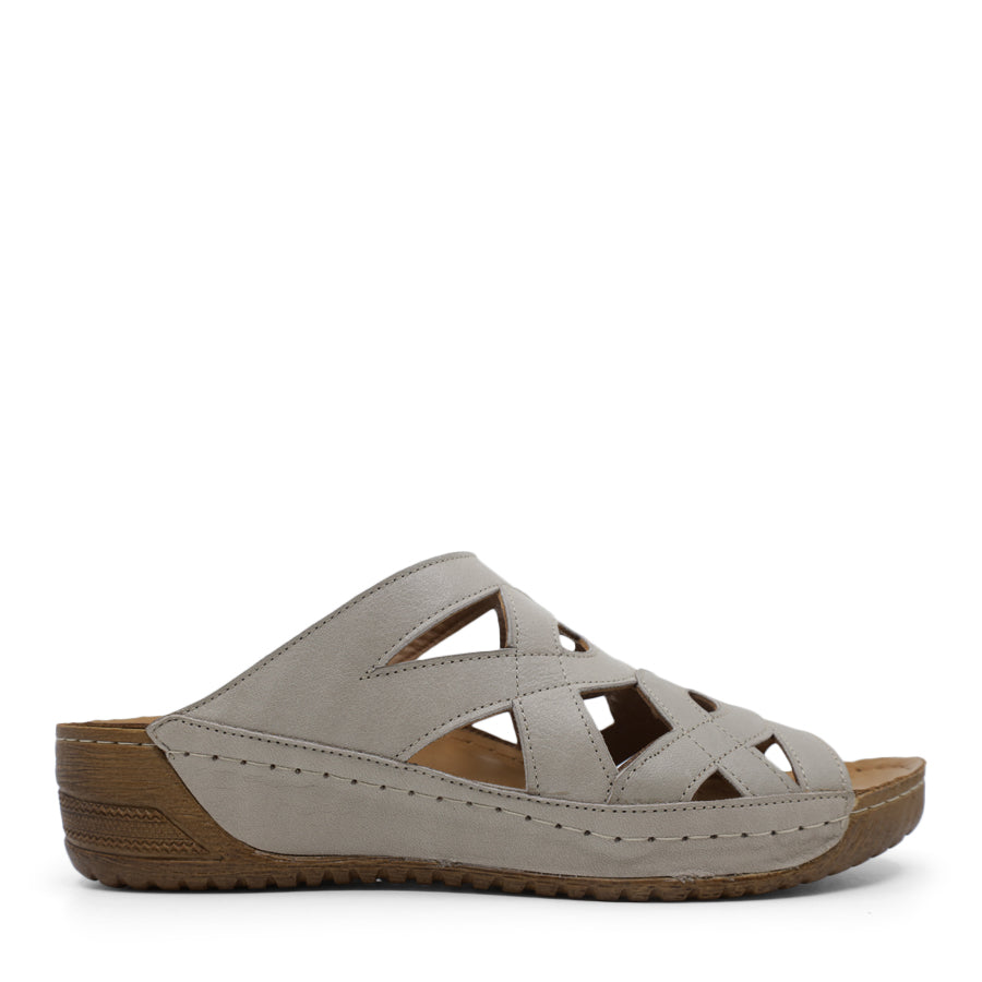 SIDE VIEW OF LIGHT GREEN MULE WITH SMALL HEEL